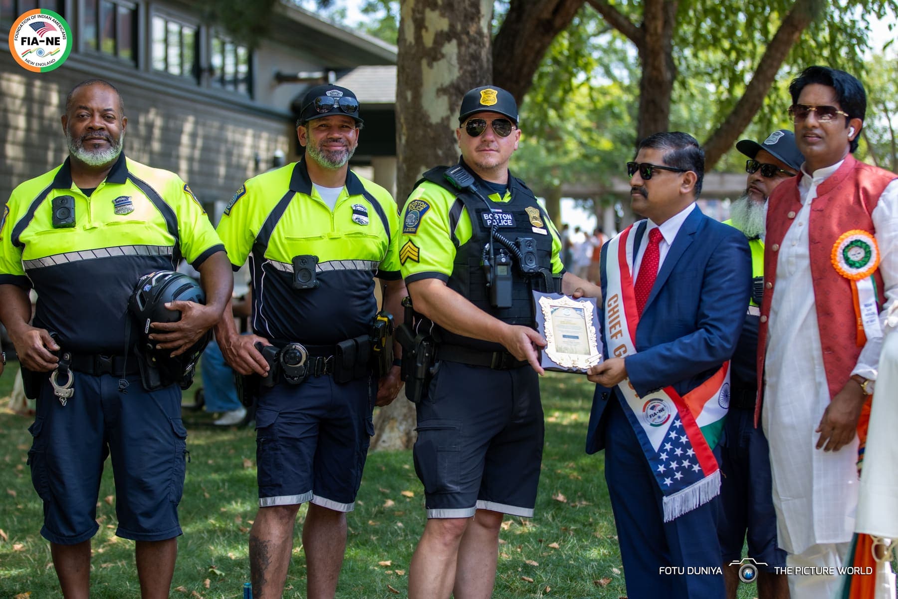FIA-NE organizers presenting a plaque of appreciation to Boston Police officers who supported the parade