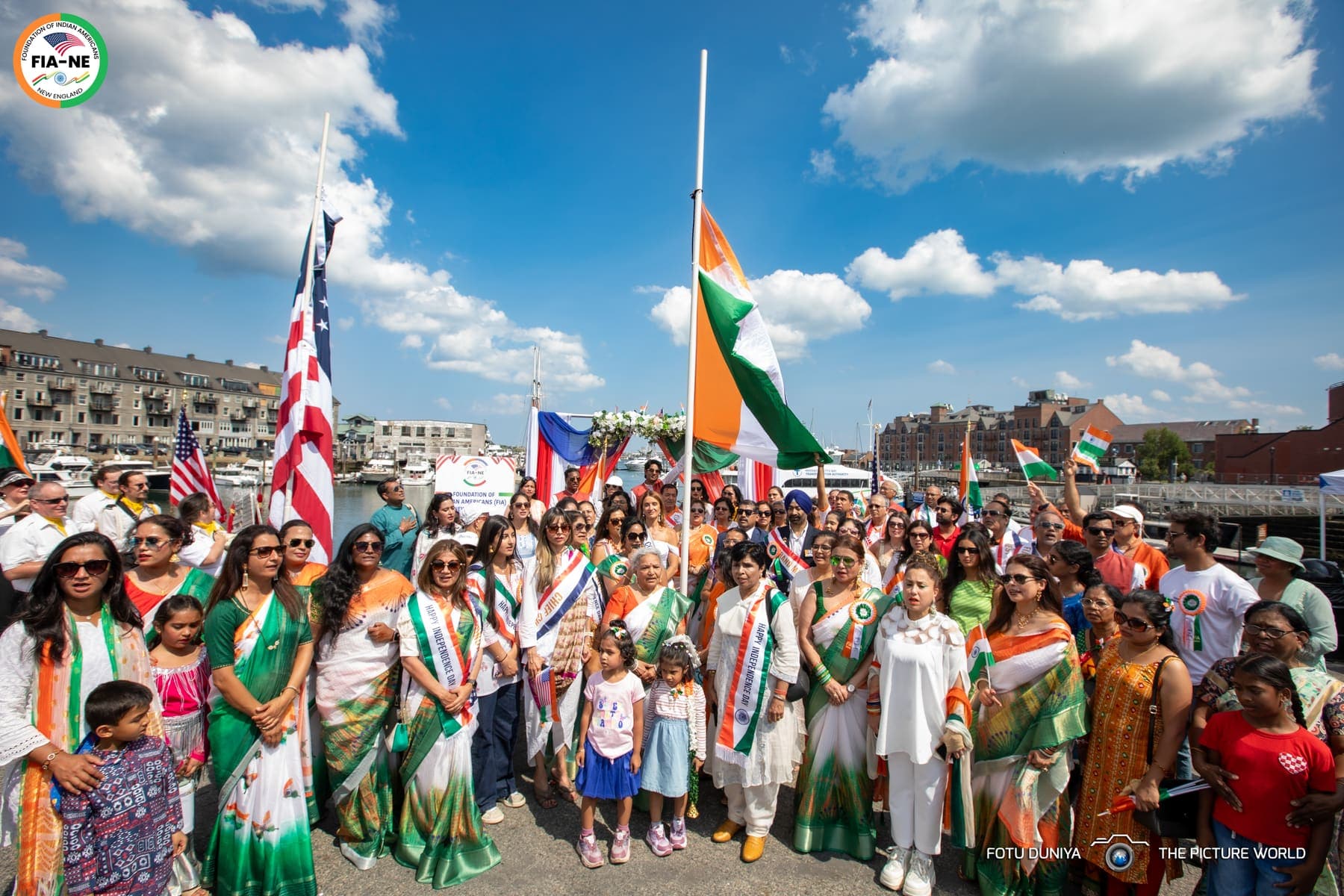 A large crowd gathered at Boston Harbor as the Indian flag is raised alongside the American flag