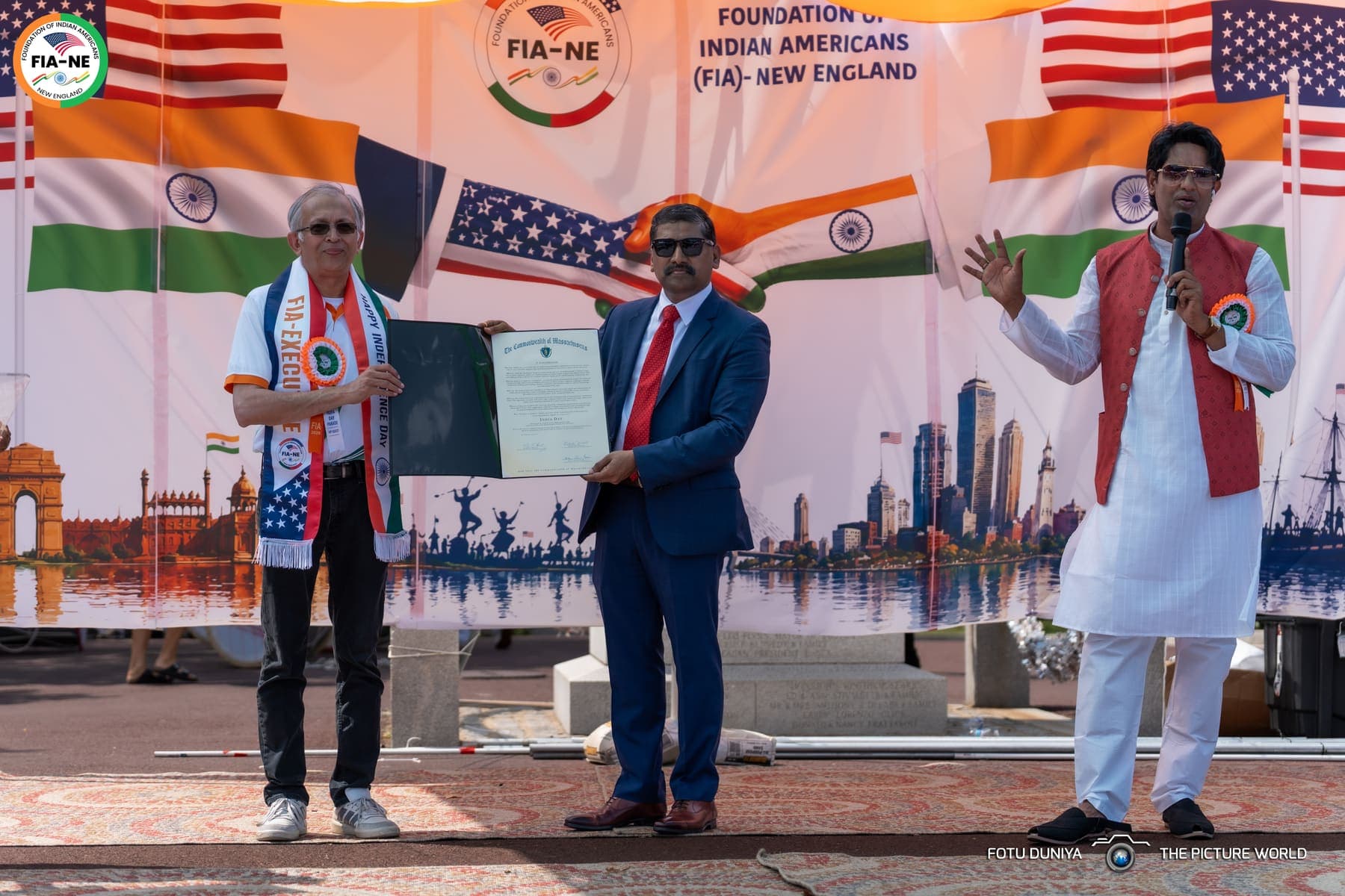 FIA-NE representatives holding a signed Commonwealth of Massachusetts proclamation honoring India Day