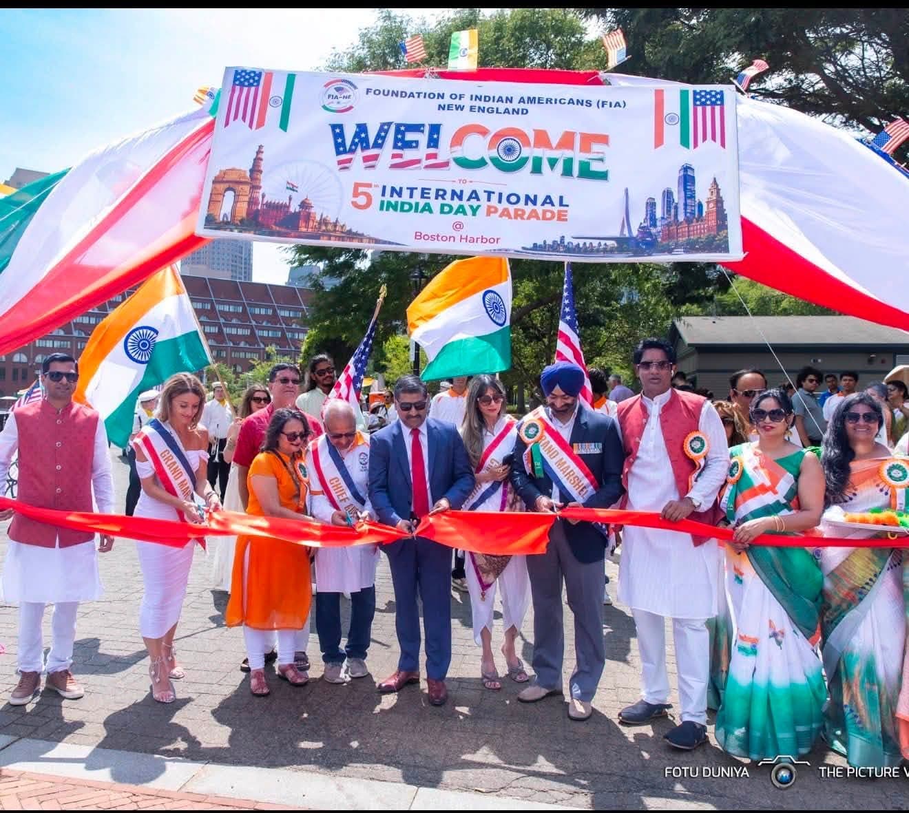 Dignitaries and grand marshals cutting the ribbon to open the 5th International India Day Parade at Boston Harbor